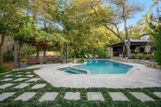 view of pool with an in ground hot tub and a patio