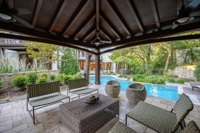 view of patio / terrace with a fenced in pool, ceiling fan, and an outdoor living space