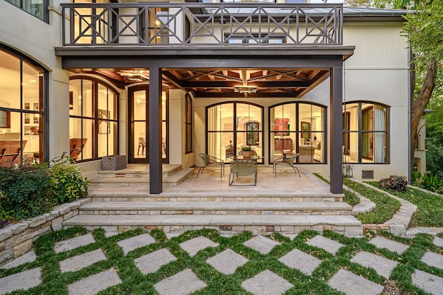 property entrance with a patio and a balcony