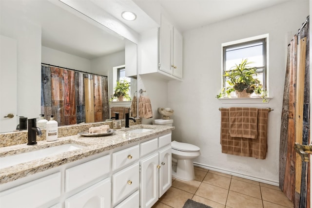 bathroom featuring tile patterned flooring, vanity, and toilet