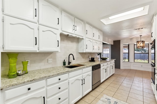 kitchen with pendant lighting, white cabinetry, dishwasher, sink, and light tile patterned floors