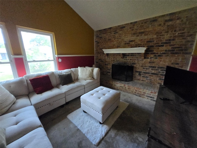 living room with lofted ceiling and a brick fireplace