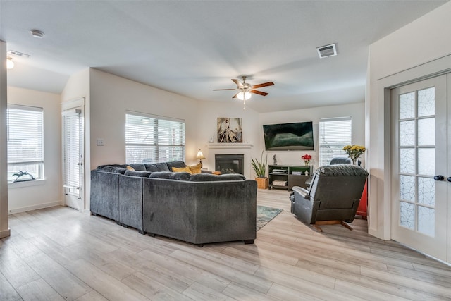 living room featuring ceiling fan and light hardwood / wood-style flooring