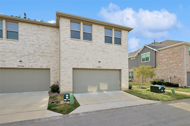 view of front of house featuring a garage and central AC