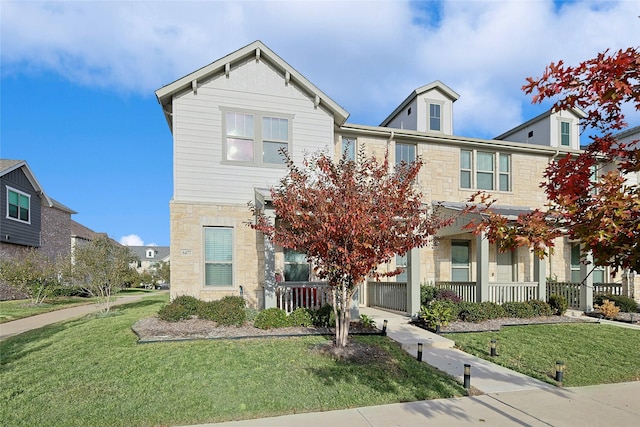 view of front of property with covered porch and a front lawn