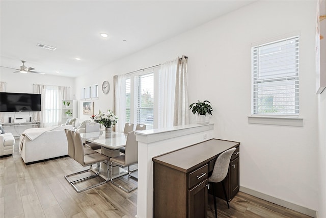 dining room featuring light hardwood / wood-style flooring and ceiling fan