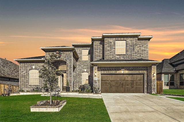 view of front facade featuring a garage and a lawn