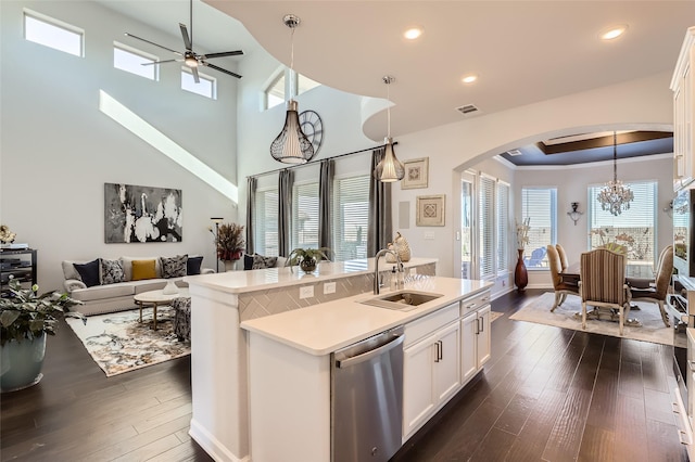 kitchen with white cabinets, sink, dark hardwood / wood-style floors, a kitchen island with sink, and stainless steel dishwasher