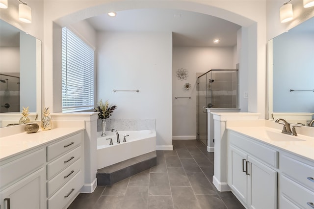 bathroom featuring plus walk in shower, tile patterned flooring, and vanity