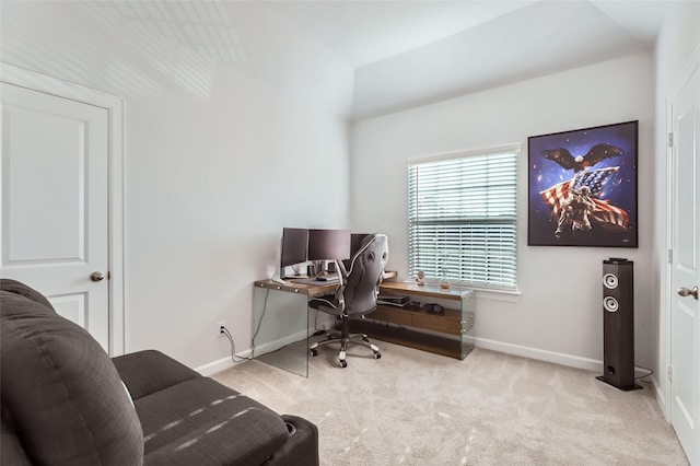 carpeted office space with vaulted ceiling