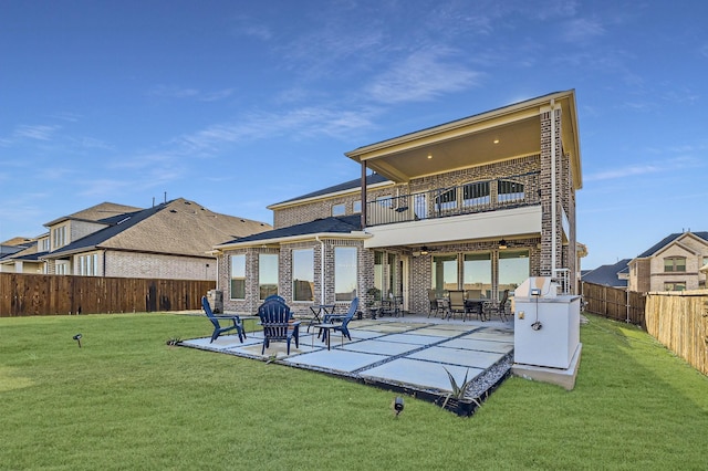 back of property featuring a patio area, a lawn, and a balcony