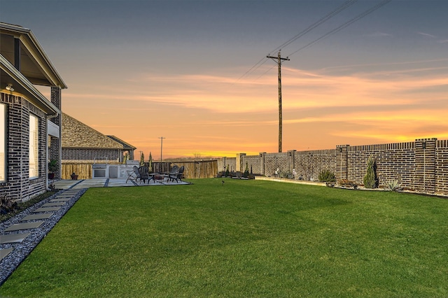 yard at dusk with a patio