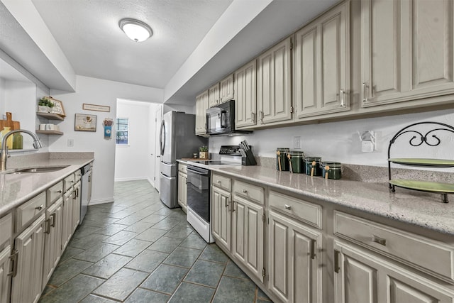 kitchen featuring sink, a textured ceiling, and appliances with stainless steel finishes