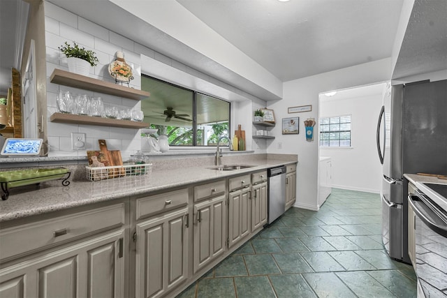 kitchen with decorative backsplash, ceiling fan, sink, and appliances with stainless steel finishes