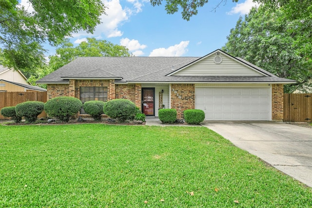 ranch-style home with a garage and a front lawn