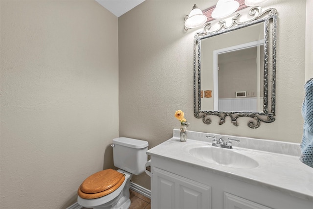 bathroom with tile patterned flooring, vanity, and toilet