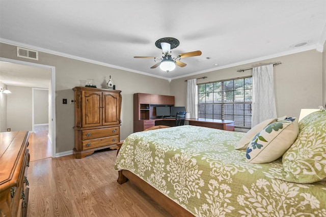 bedroom featuring ceiling fan, light hardwood / wood-style floors, and crown molding