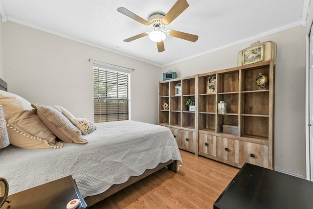 bedroom featuring ceiling fan, light hardwood / wood-style floors, and ornamental molding