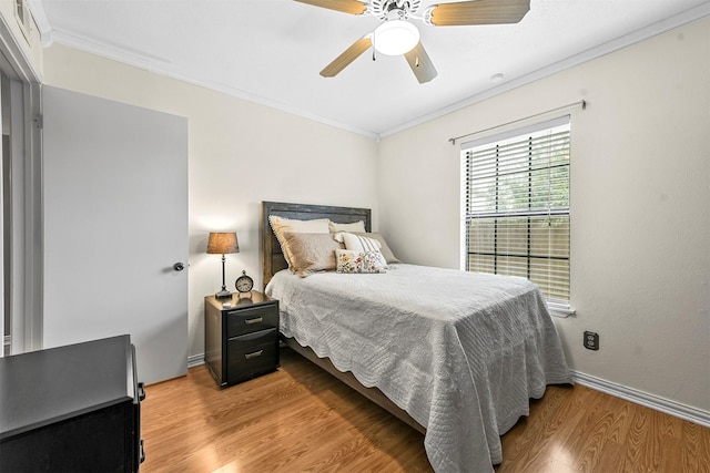 bedroom featuring ceiling fan, crown molding, and hardwood / wood-style flooring