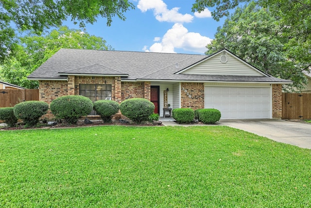 ranch-style home featuring a front lawn and a garage