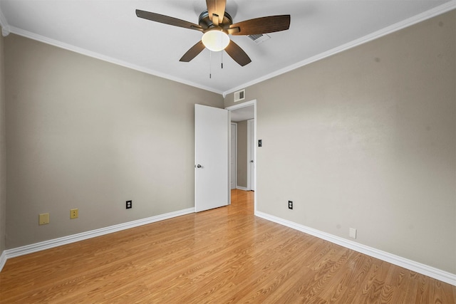 empty room featuring ceiling fan, light hardwood / wood-style flooring, and ornamental molding