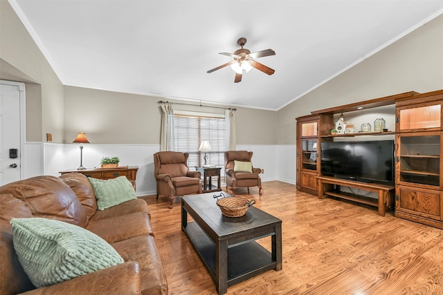 living room with ceiling fan, light hardwood / wood-style floors, crown molding, and vaulted ceiling