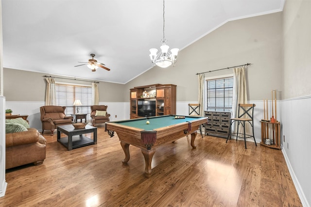 rec room with lofted ceiling, a healthy amount of sunlight, and ornamental molding