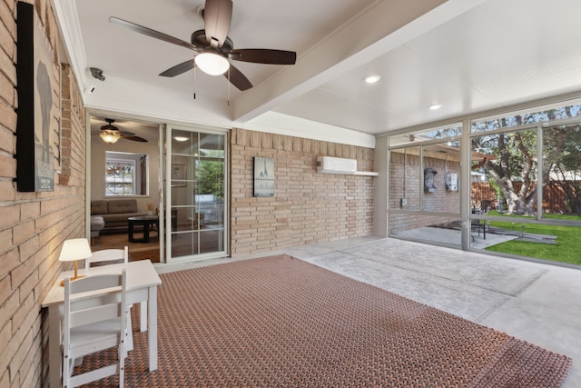 unfurnished sunroom with beam ceiling, a wealth of natural light, ceiling fan, and a wall unit AC