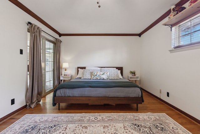 bedroom with crown molding, hardwood / wood-style flooring, and multiple windows