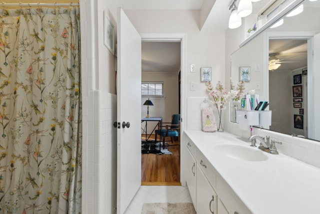 bathroom featuring walk in shower, ceiling fan, and vanity