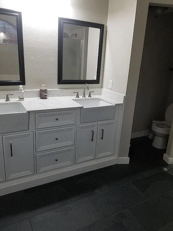 bathroom featuring tile patterned floors, vanity, and toilet