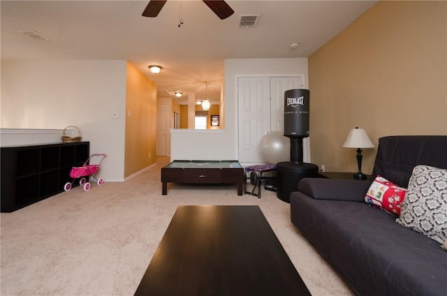 living room with carpet flooring and ceiling fan