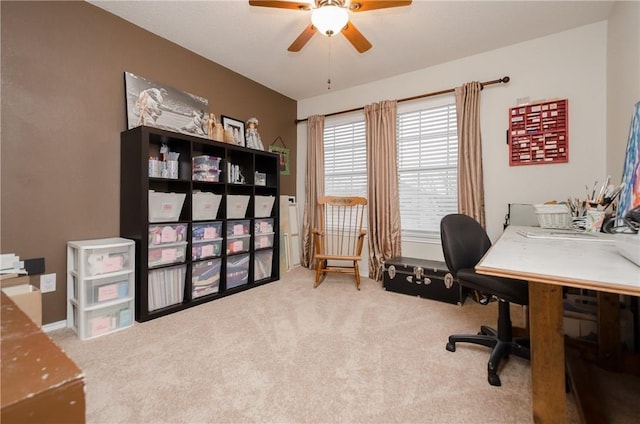 carpeted home office featuring ceiling fan