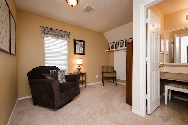 sitting room featuring light carpet and vaulted ceiling