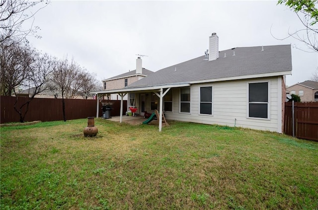 back of house featuring a yard and a patio