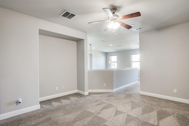 carpeted empty room featuring ceiling fan and sink