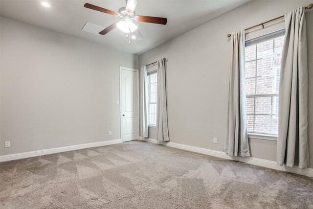 unfurnished bedroom featuring ceiling fan, ensuite bathroom, and light carpet