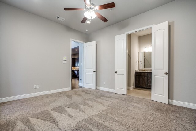 bathroom with tile patterned floors, ceiling fan, a shower with door, and vanity