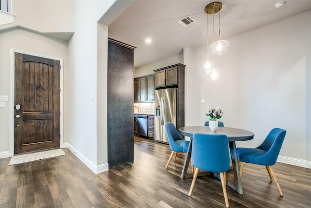 dining space featuring baseboards, visible vents, and dark wood-type flooring