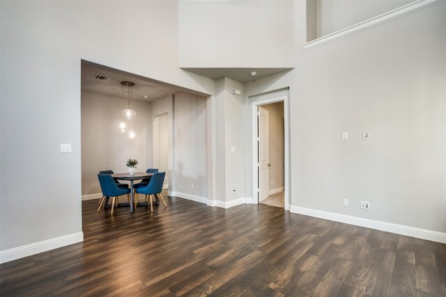 kitchen featuring light stone countertops, appliances with stainless steel finishes, tasteful backsplash, dark brown cabinetry, and hanging light fixtures