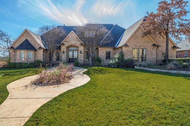 french provincial home featuring a front lawn