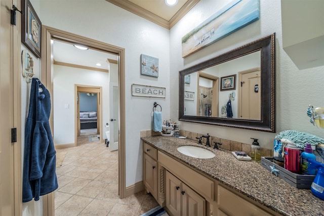 bathroom featuring tile patterned floors, crown molding, and vanity