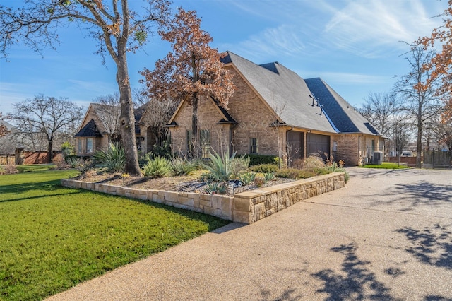 view of property exterior featuring a lawn and a garage