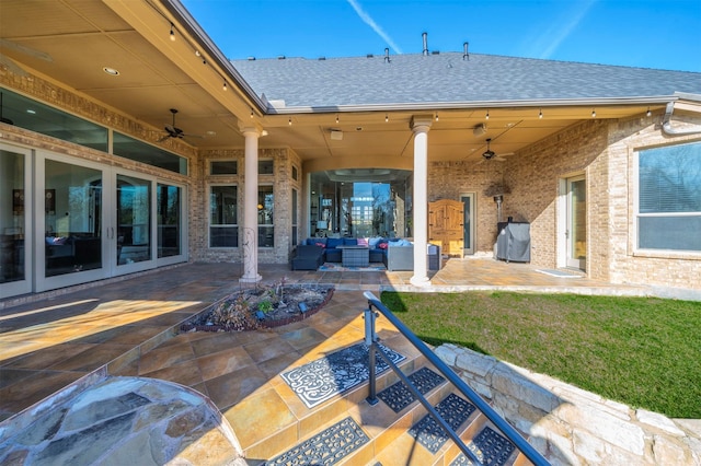 view of patio featuring french doors, an outdoor living space, and ceiling fan