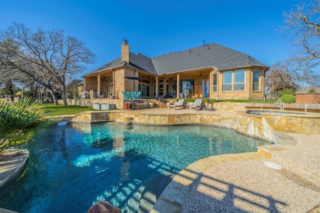 view of pool featuring a patio area and an in ground hot tub