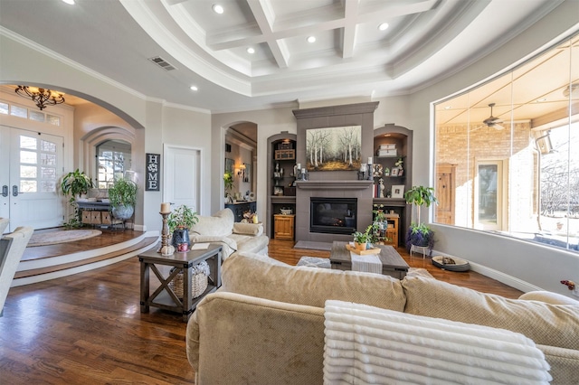 living room with beamed ceiling, a healthy amount of sunlight, ornamental molding, and coffered ceiling