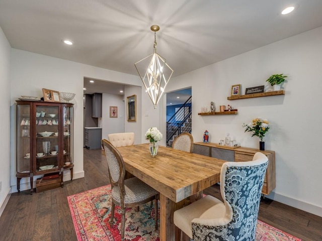 dining space featuring a chandelier and dark hardwood / wood-style flooring