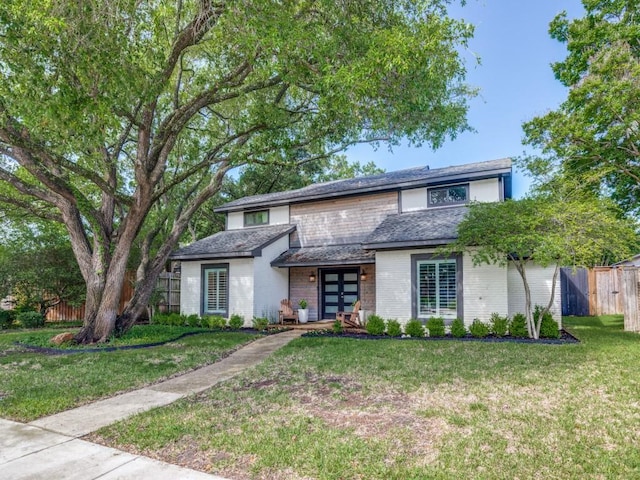 view of front of house with a front yard and french doors