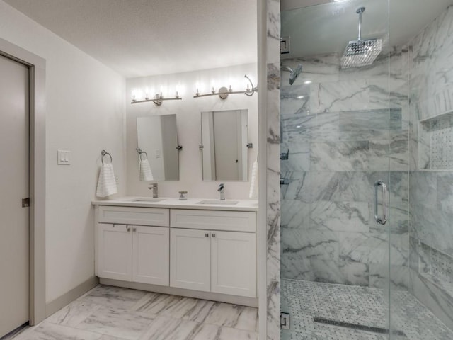 bathroom with a shower with door and vanity