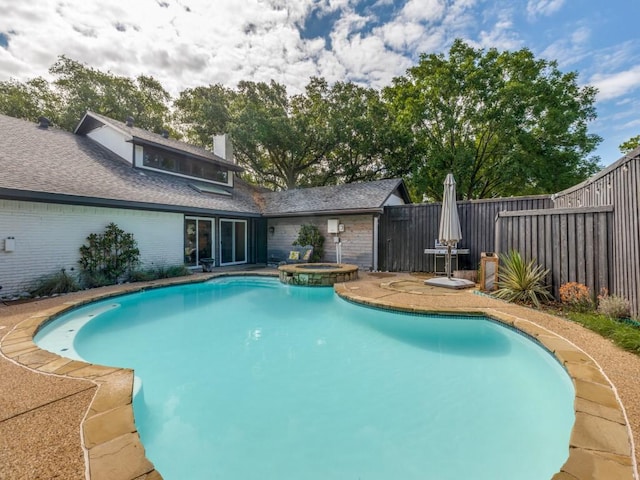 view of swimming pool featuring an in ground hot tub